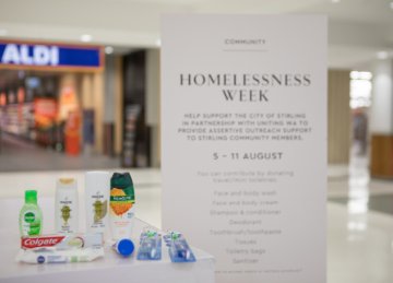 A Homelessness Week sign and toiletries
